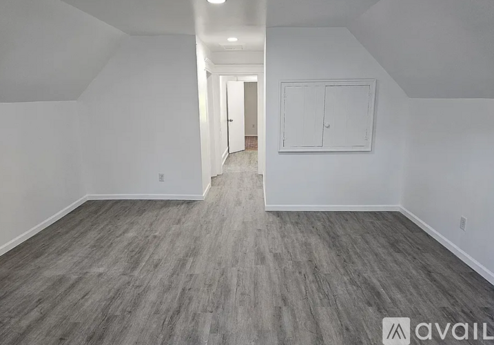 A room with a grey floor and white walls.