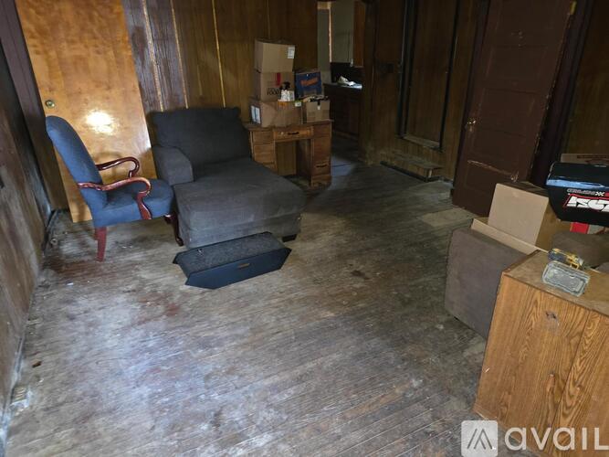 A room with a chair and a box on the floor.