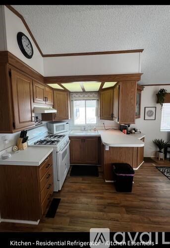 A kitchen with wooden cabinets and a white countertop.