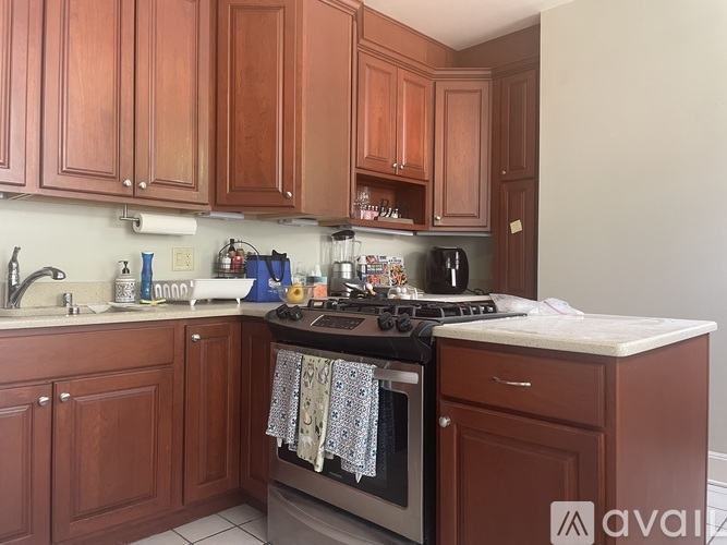 A kitchen with wooden cabinets and a black stove top.