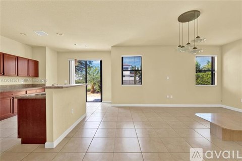 A spacious kitchen with brown cabinets and a countertop.