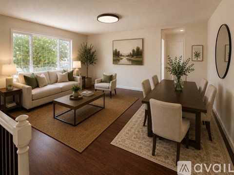 A living room with a white couch, a coffee table, and a dining table with chairs.