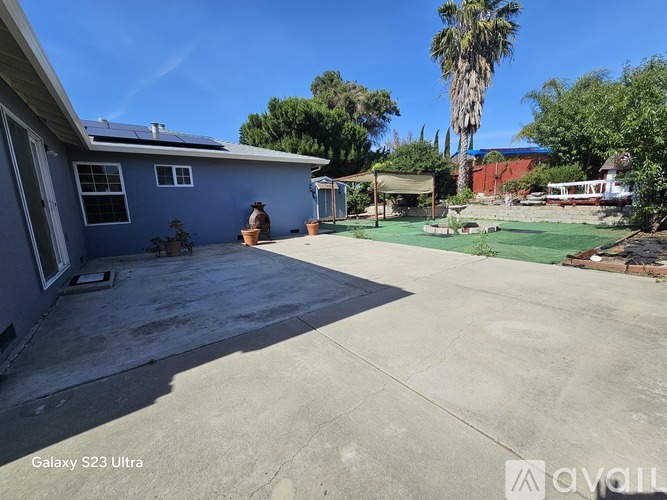 A house with a blue exterior and a concrete driveway.