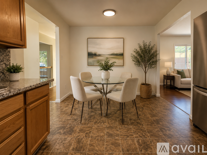 A dining room with a table and chairs.