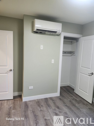 A room with a Galaxy S23 FE air conditioner mounted on the wall.