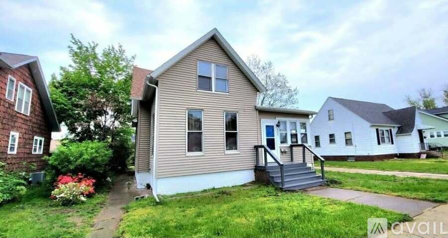 A house with a front yard and a tree.