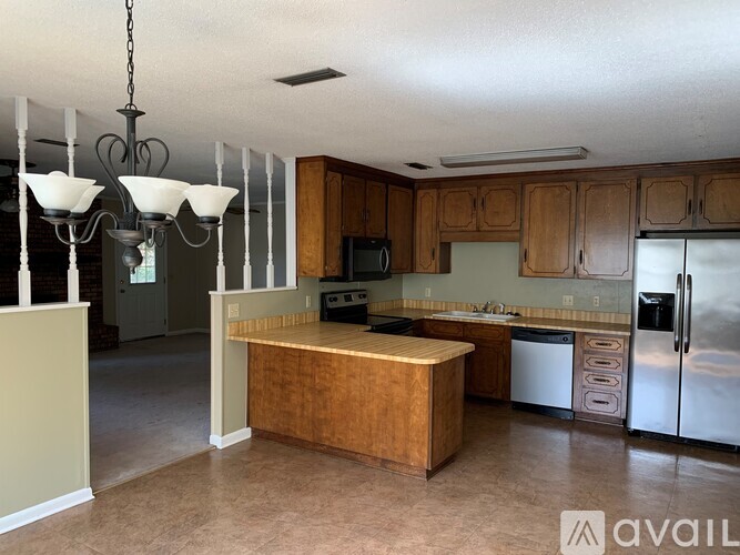 A kitchen with wooden cabinets and a wooden island.