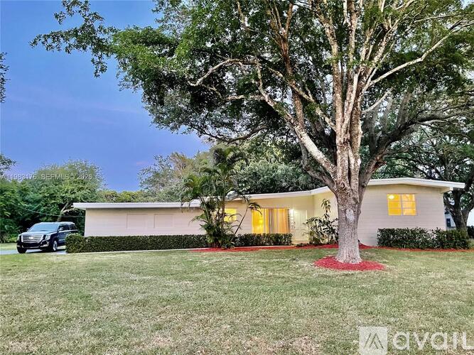 A house with a tree in front of it.