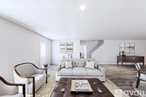 A living room with a white couch and a brown coffee table.