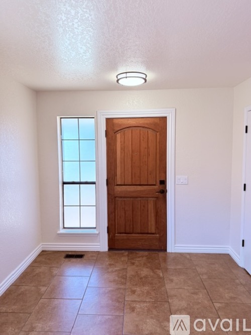A room with a brown door and a window.