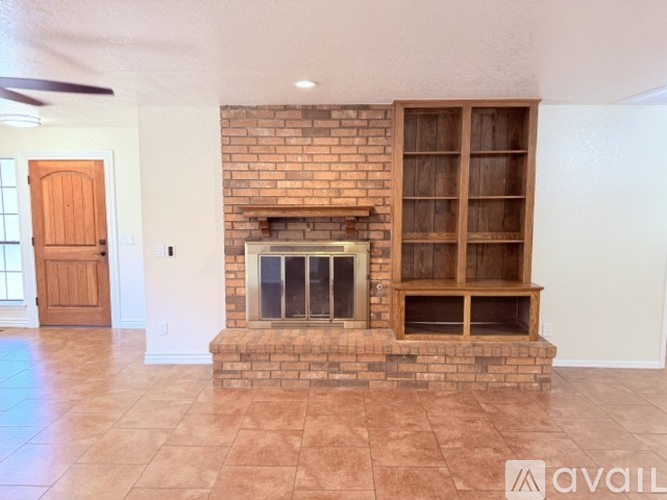 A living room with a fireplace and a fan.
