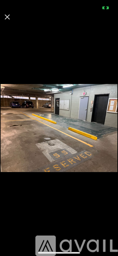 A parking garage with a yellow line and a sign that says "E 55 SERVED".