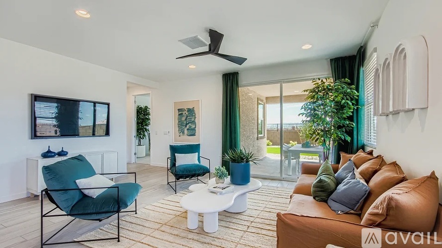 A living room with a brown couch, a blue chair, and a white coffee table.