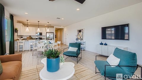A living room with a white coffee table and a blue plant pot.