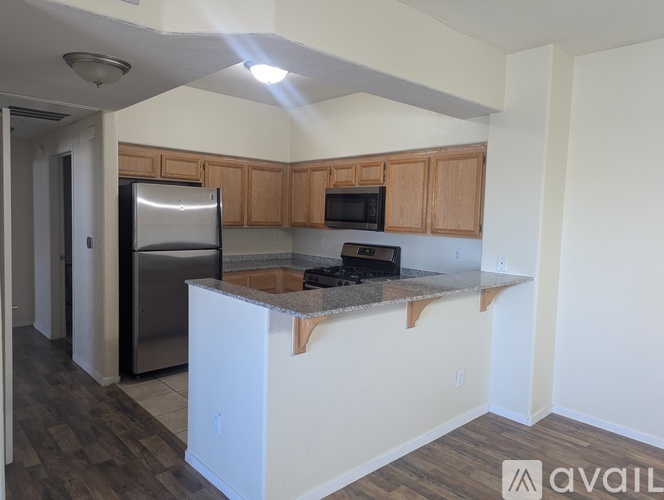 A kitchen with wooden cabinets and a white island.