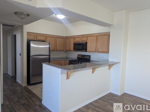 A kitchen with wooden cabinets and a white island.