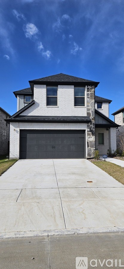 A modern house with a black garage door.