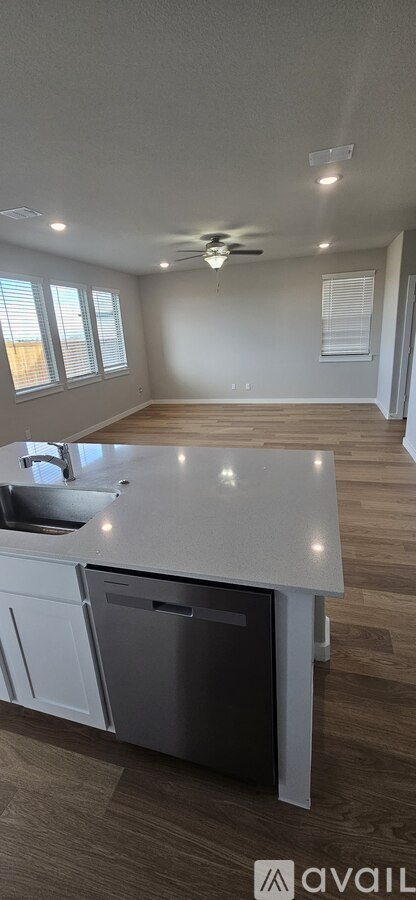 A kitchen with a dishwasher and a ceiling fan.