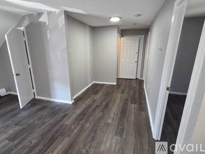 A room with a wooden floor and white walls.