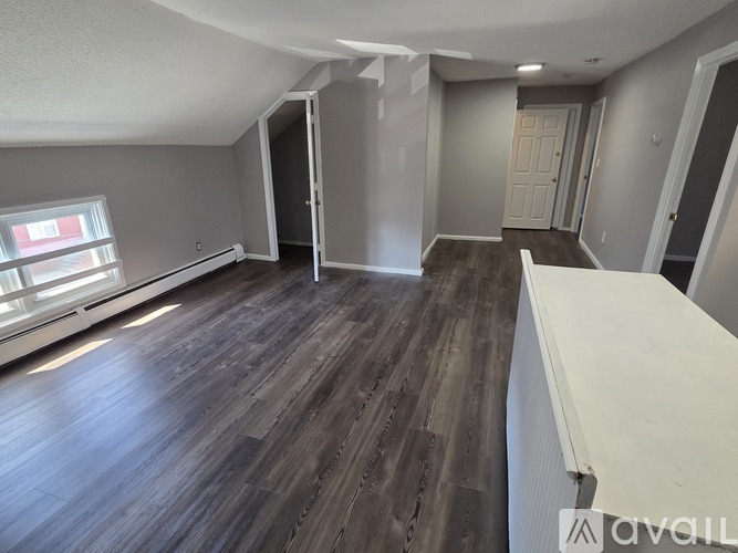 A room with wooden flooring and a white counter.
