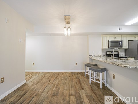 A kitchen with a bar stool and a counter.