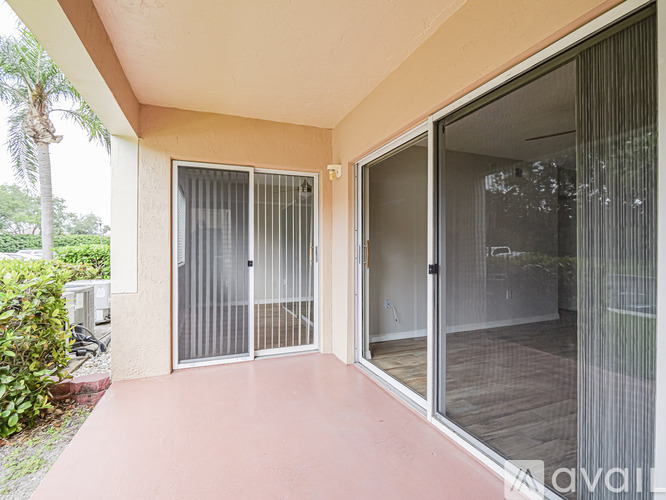 A patio area with sliding glass doors and a red floor.