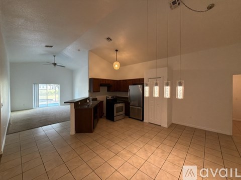 A kitchen with a refrigerator, microwave, and oven is available for rent.
