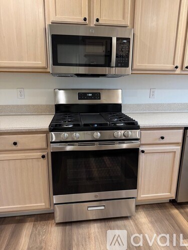 A kitchen with a stove top oven and microwave above it.