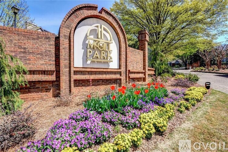 The image shows a beautiful garden in front of a sign that reads "McGill Park".