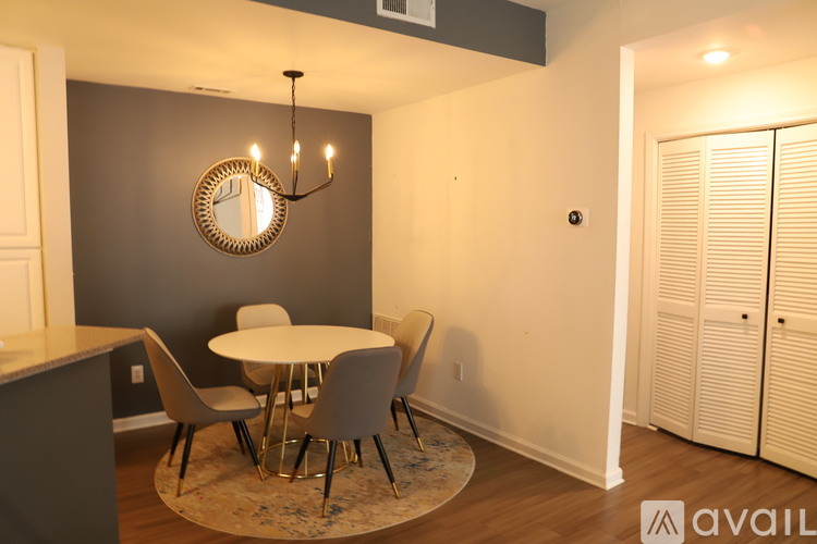 A dining room with a round table and chairs.