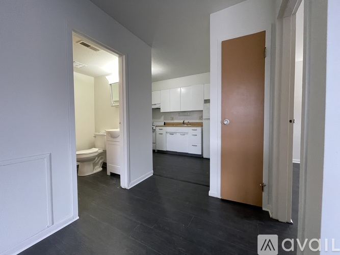 A room with a brown door and a white cabinet.