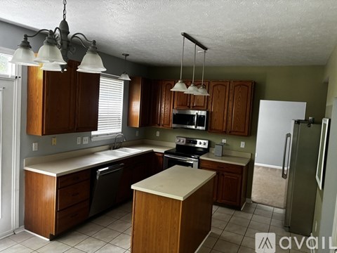 A kitchen with wooden cabinets and a white refrigerator.