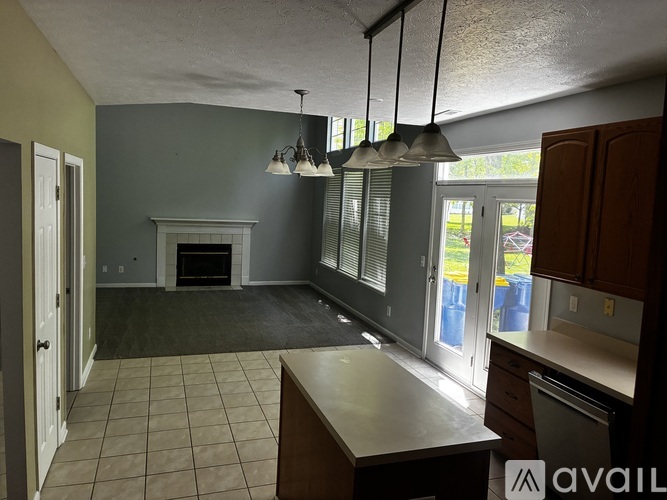 A kitchen with a fireplace and a dining table.