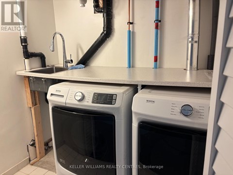 A kitchen with a Keller Williams Realty logo.