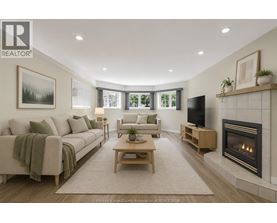 A living room with a couch, a chair, a coffee table, and a fireplace.