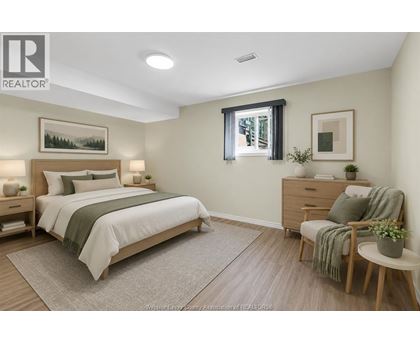 A bedroom with a bed, chair, and nightstands.