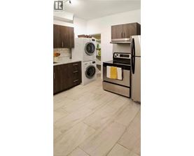 A kitchen with a white fridge and a white dishwasher.