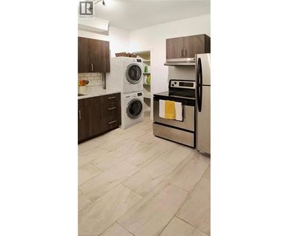 A kitchen with a white fridge and a white dishwasher.
