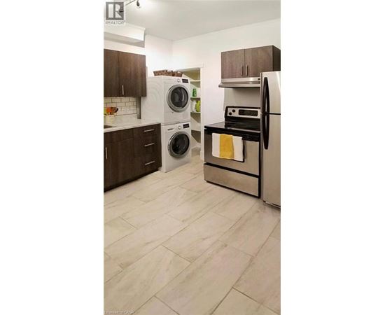 A kitchen with a white fridge and a white dishwasher.