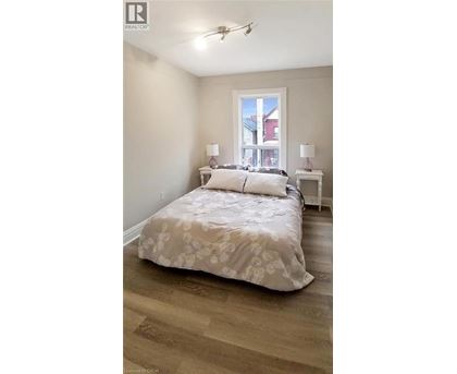A bedroom with a large bed and a window.