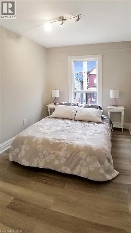 A bedroom with a large bed and a window.