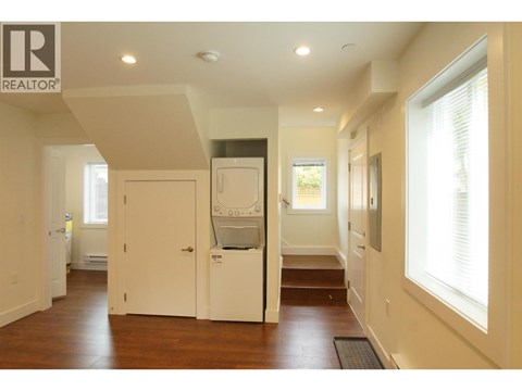 A modern kitchen with a refrigerator and a sink.