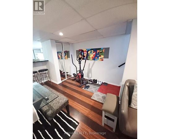 A living room with a glass table and a couch.