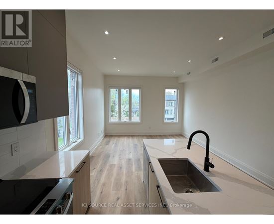 A modern kitchen with a sink and a window.
