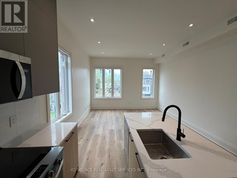 A modern kitchen with a sink and a window.