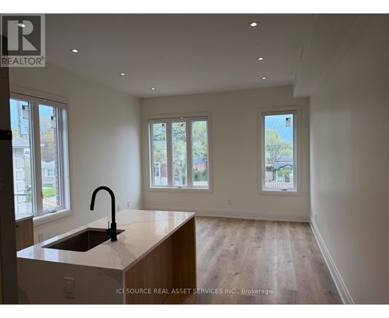 A kitchen with a sink and a window.