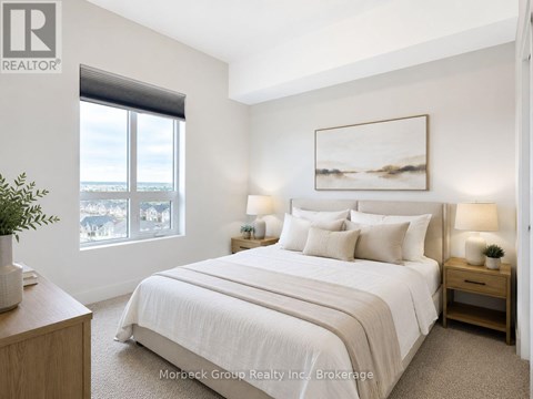 A bedroom with a large bed and a painting on the wall.