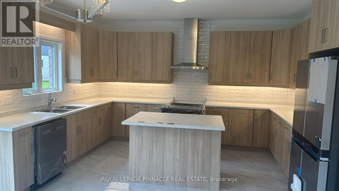 A kitchen with wooden cabinets and a central island.