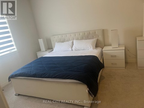 A bedroom with a bed, nightstand, and dresser.