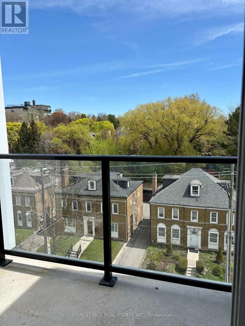 A view from a balcony overlooking a residential area.